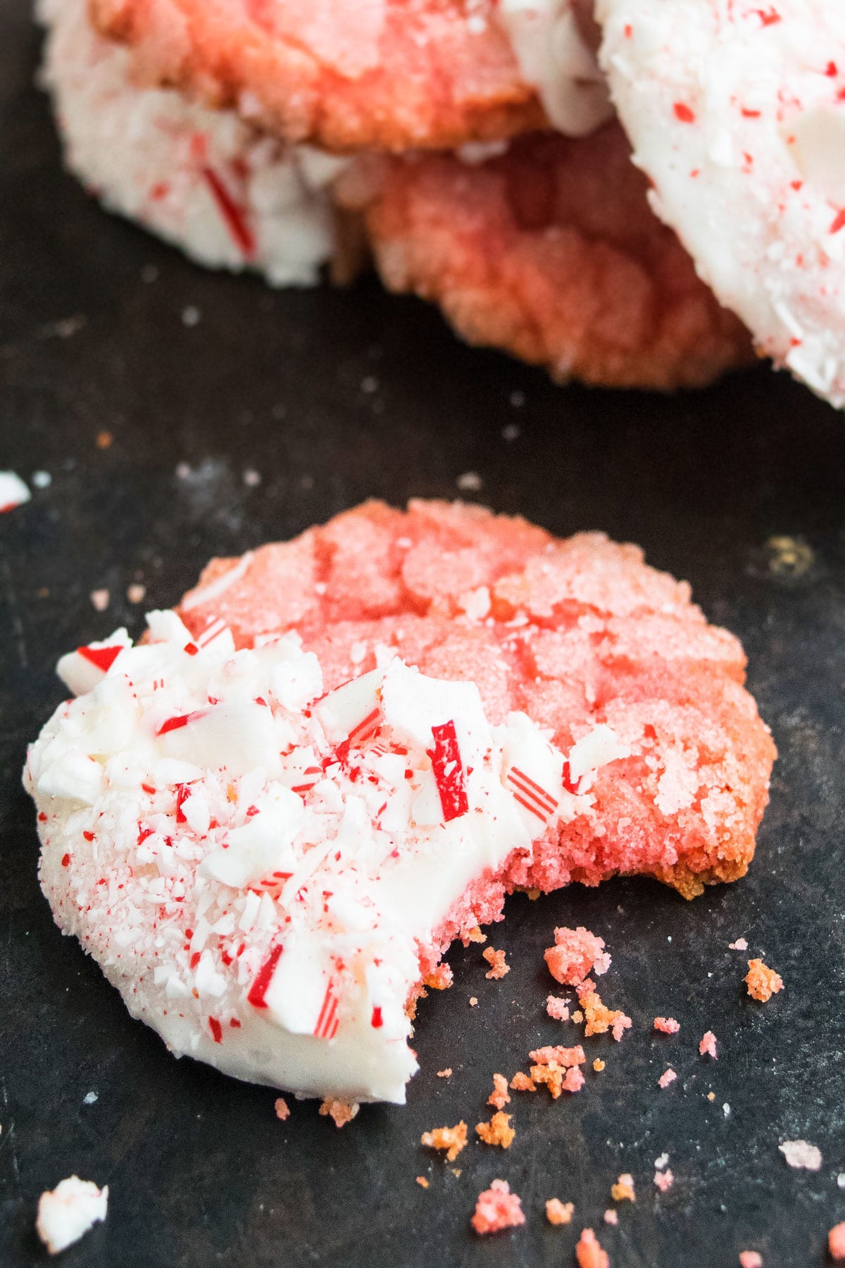 Partially Eaten Candy Cane Cookies on Rustic Gray Background.