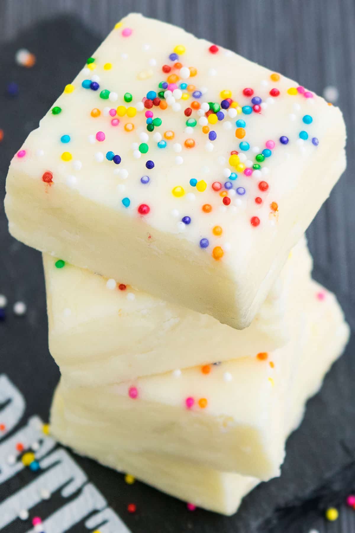 Best 2 Ingredient Fudge Stacked on Top of Each other on Gray Background. 