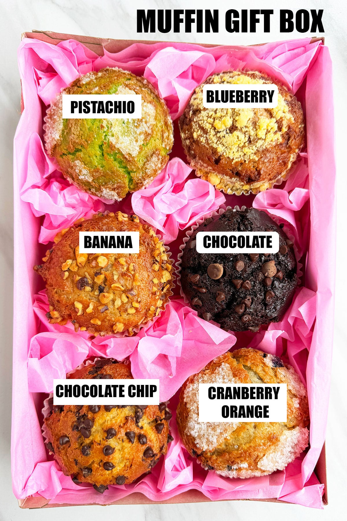 Homemade Muffin Gift Box on White Marble Background- 6 Flavors. 
