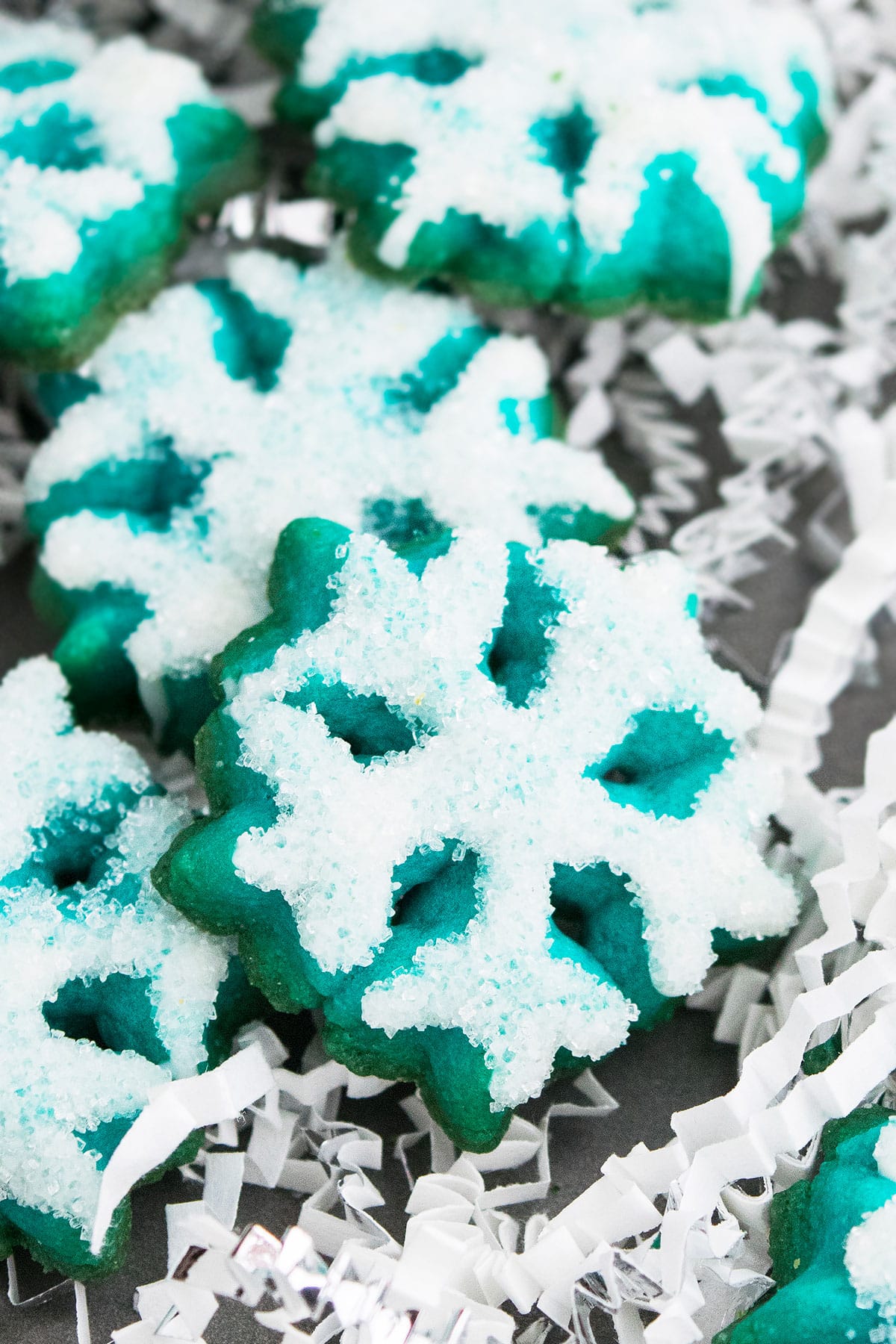 Blue Snowflake Cookies With Sparkling Sugar Made With Cookie Press on Metal Baking Tray. 