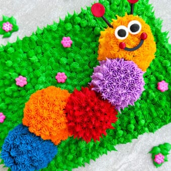 Easy Caterpillar Cake With Buttercream Icing on Light Gray Cake Board.