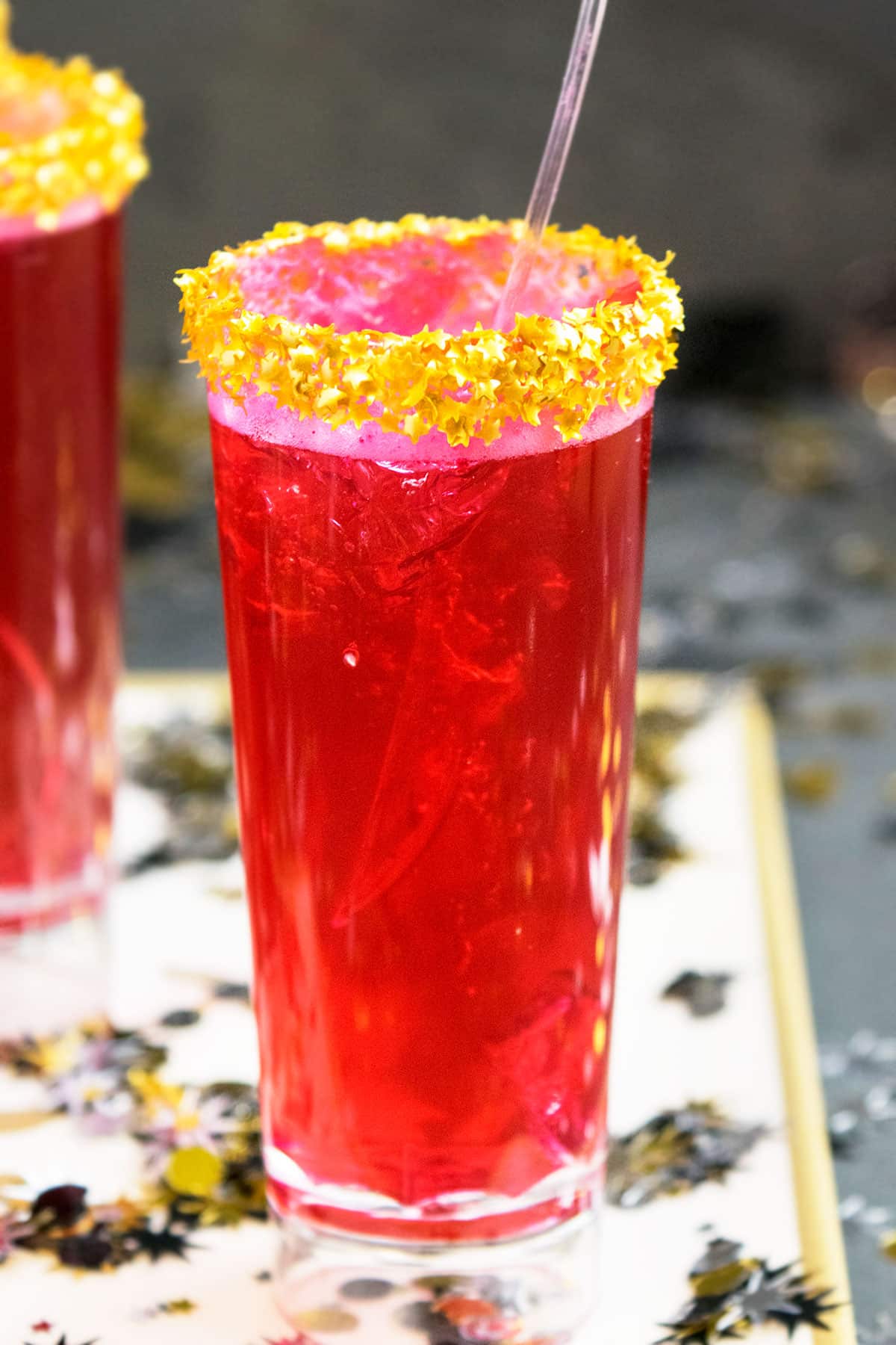 Closeup Shot of Pink Jelly Shots With Gold Sprinkle Rim on Tray With Confetti.