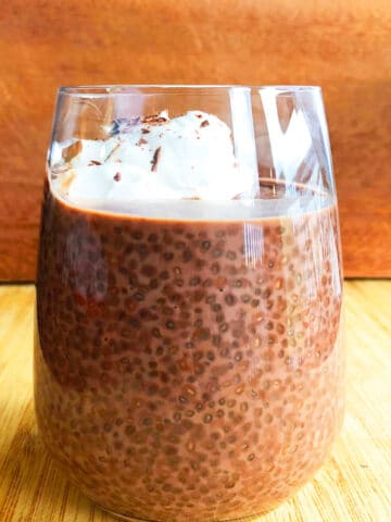 Easy Chocolate Chia Seed Pudding With Whipped Cream in Glass Cup.