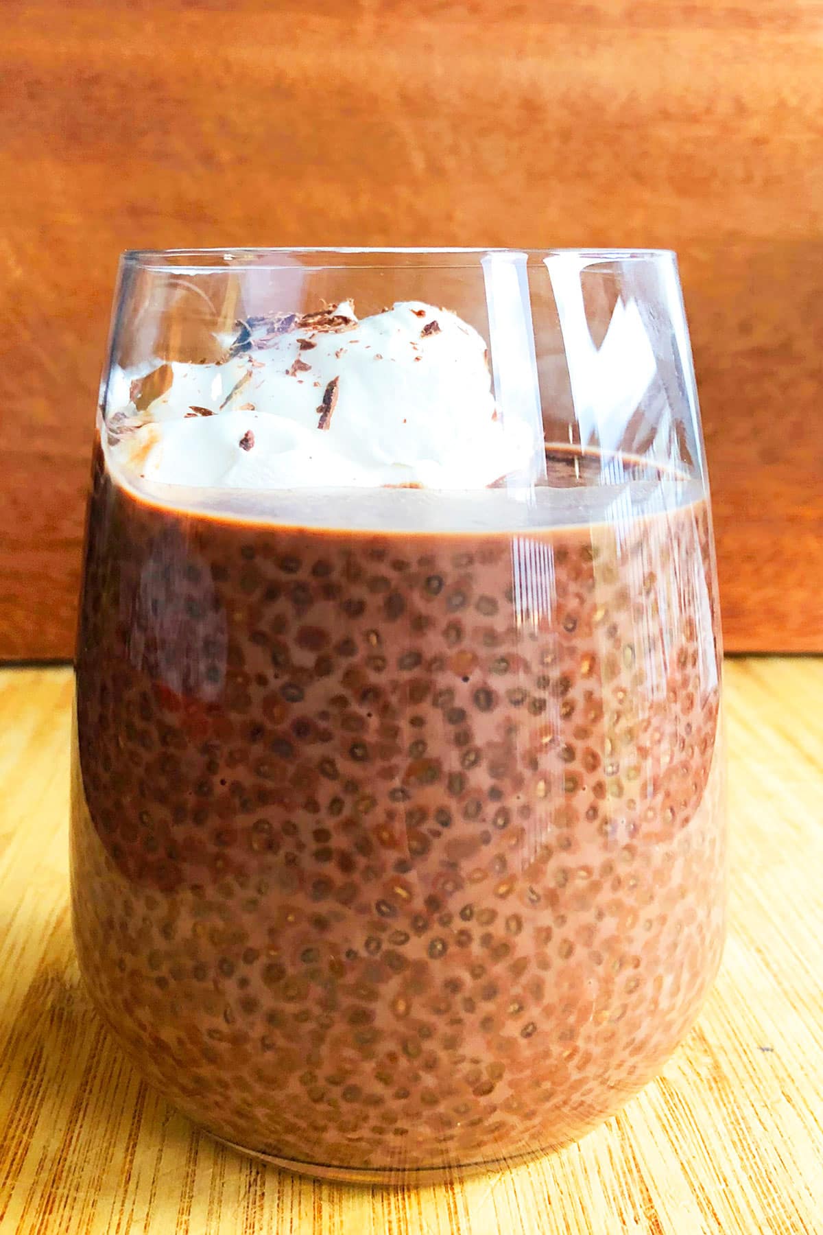 Easy Chocolate Chia Seed Pudding With Whipped Cream in Glass Cup.