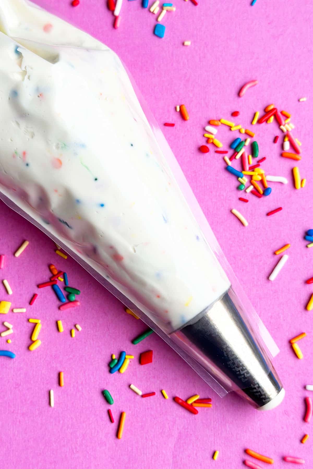 Piping Bag Filled With Vanilla Buttercream Frosting With Sprinkles.