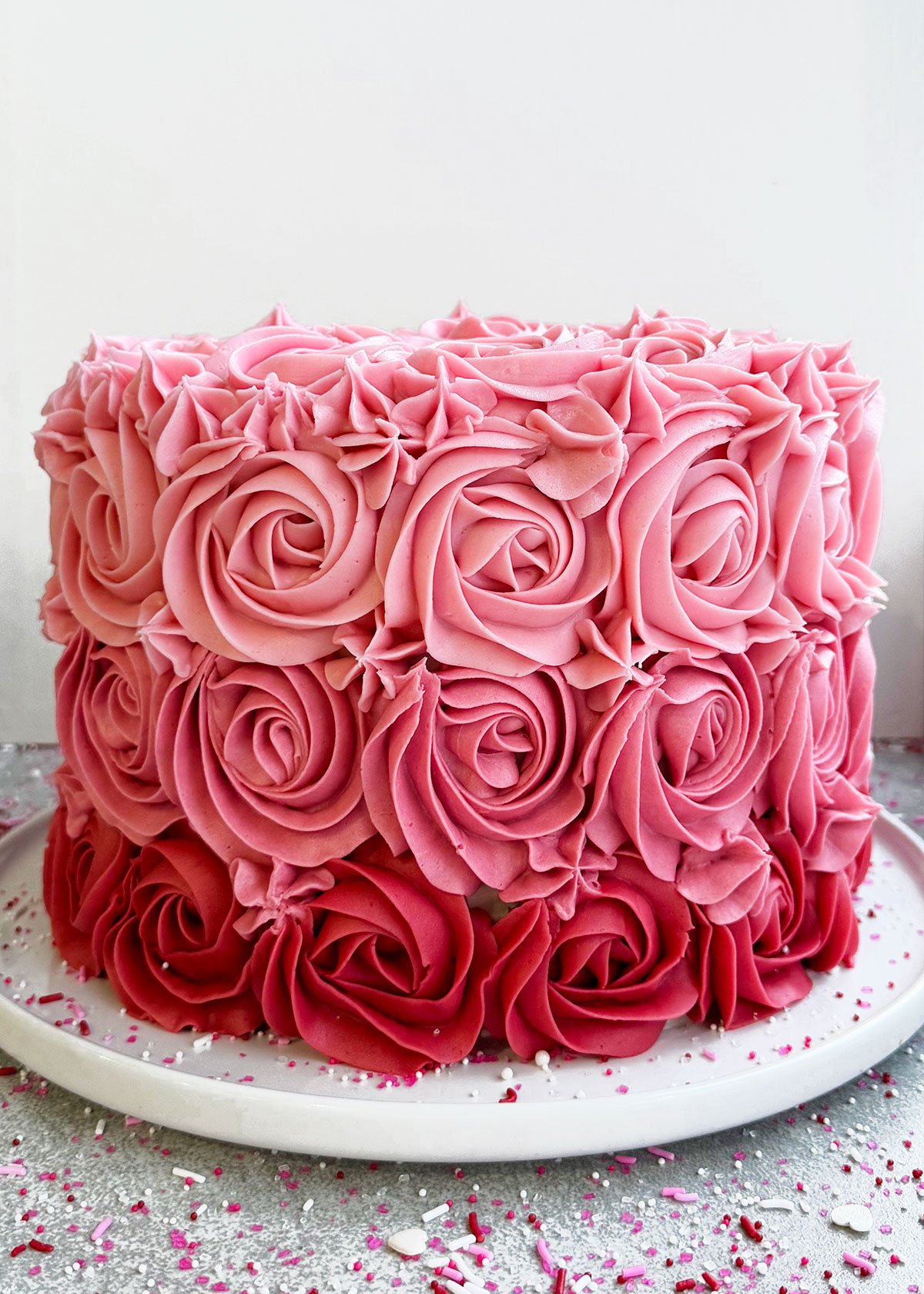 Easy Mother's Day Cake (Pink Ombre Cake) on White Dish. 