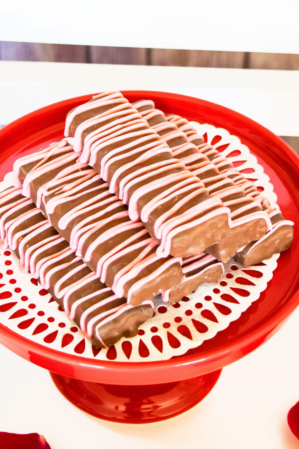 Chocolate Covered Granola Bars on Red Cake Stand.