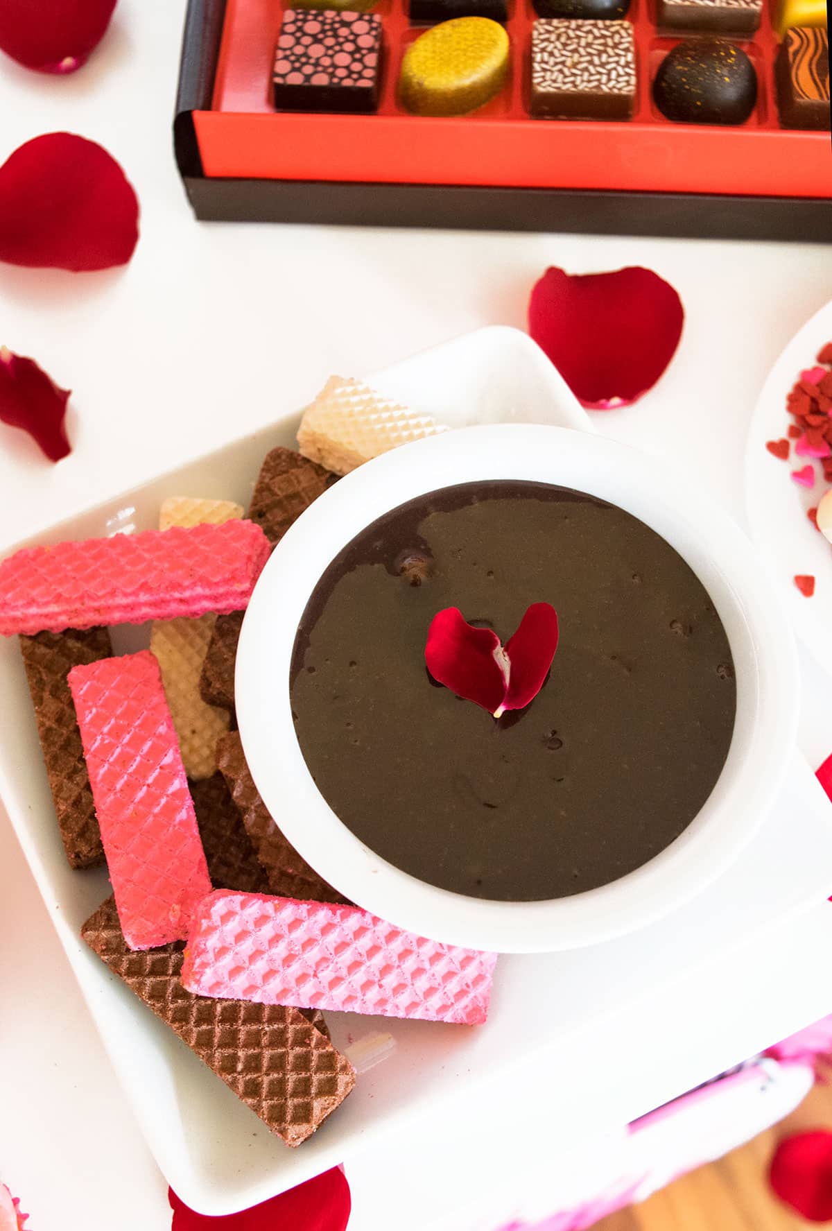 Chocolate Dip in White Bowl With Rose Petals and Wafers.