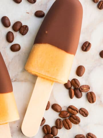 Easy Iced Coffee Popsicles on Marble Background With Coffee Beans.
