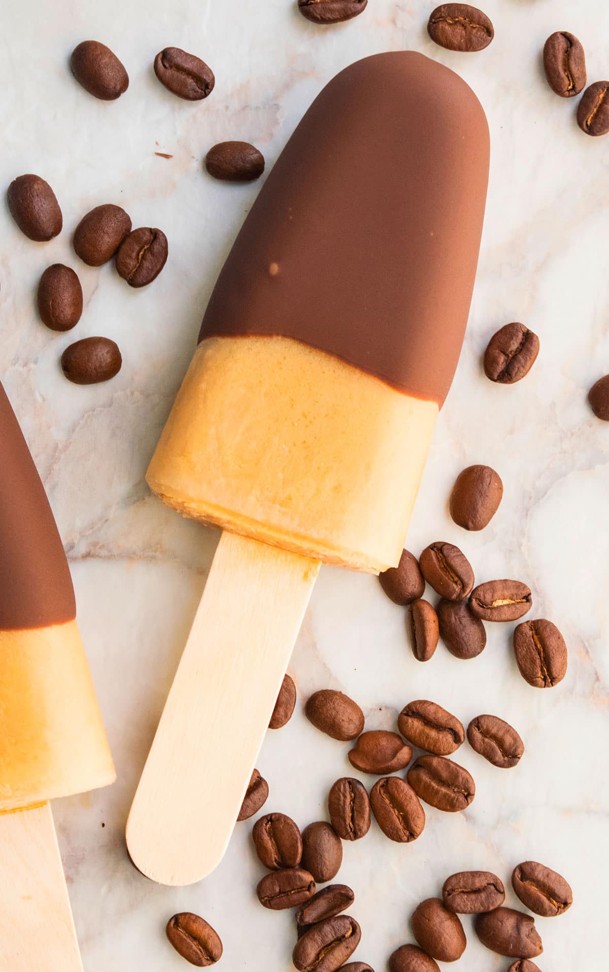 Easy Iced Coffee Popsicles on Marble Background With Coffee Beans. 