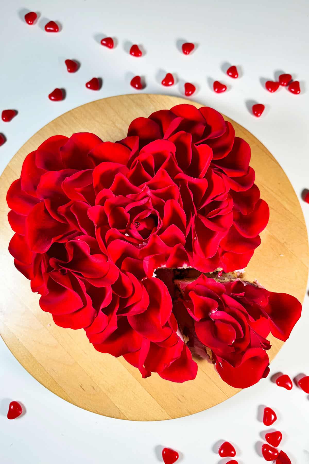 Easy Red Rose Cake With Fresh Flower Petals on Wood Cake Stand. 