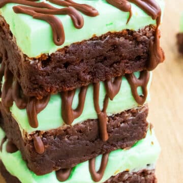 Stack of Chocolate Mint Brownies With Mint Buttercream Frosting on Wood Background.