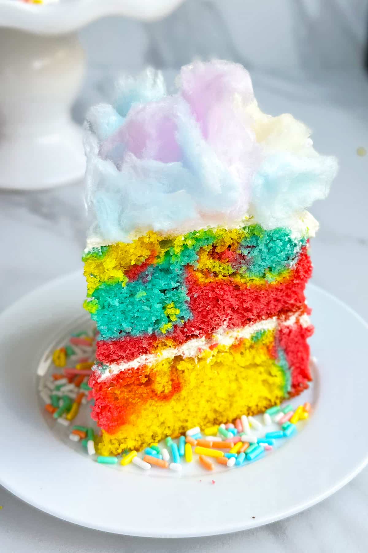 Slice of Colorful Layer Cake on White Dish. 