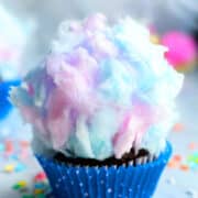 Easy Cotton Candy Cupcakes in Polka Dot Blue Liner on a Marble Background.