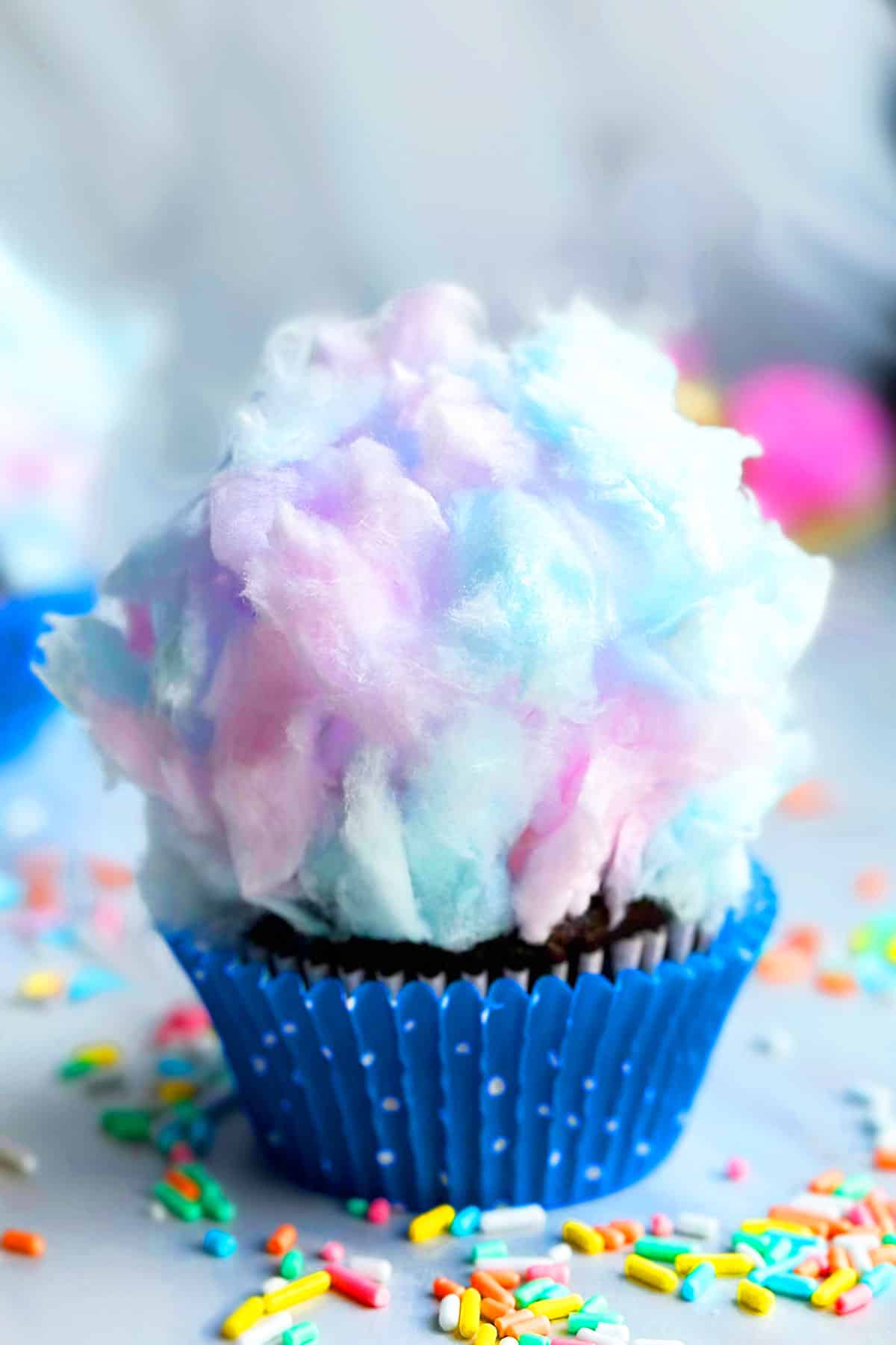 Easy Cotton Candy Cupcakes in Polka Dot Blue Liner on Marble Background. 