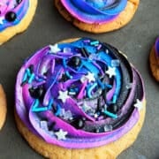 Easy Galaxy Cookies With Buttercream Icing and Sprinkles on Metallic Gray Tray.