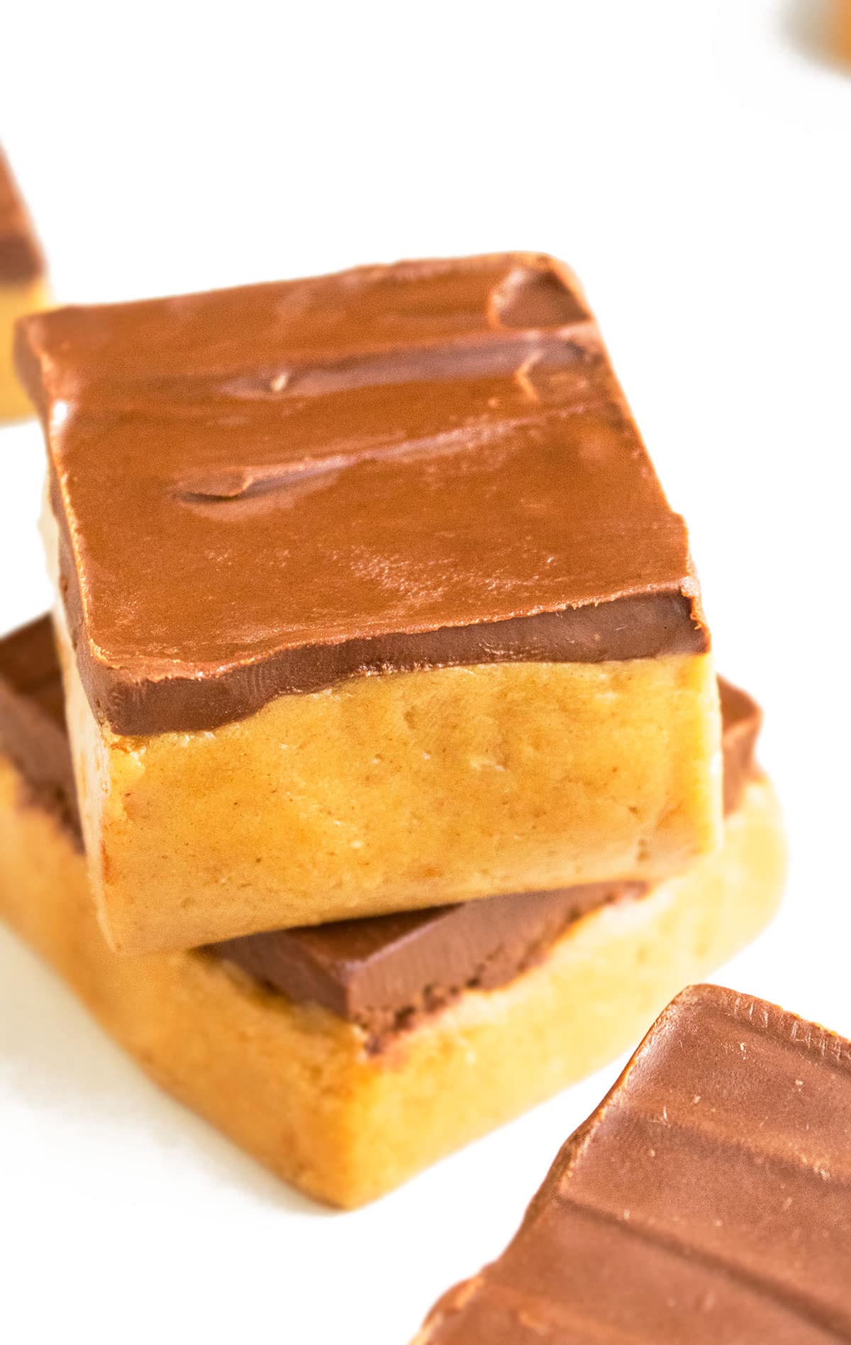 Stack of Easy No Bake Peanut Butter Bars on White Background.