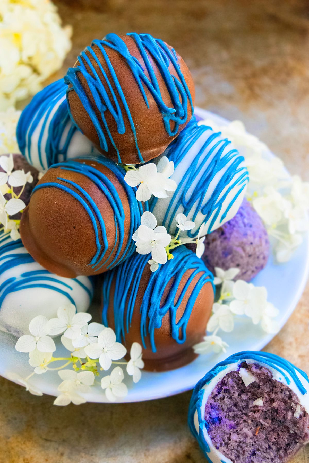 Stack of Easy Chocolate Blueberry Truffles on White Dish. 