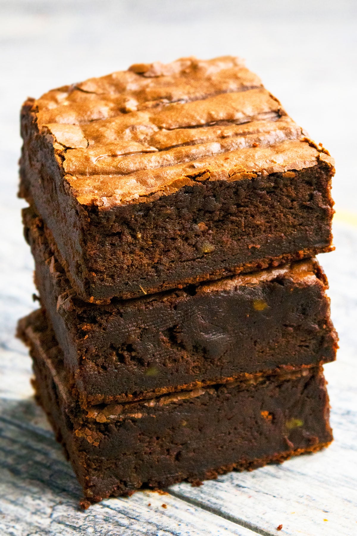 Stack of Fudgy Chocolate Avocado Brownies on Rustic Gray Background. 