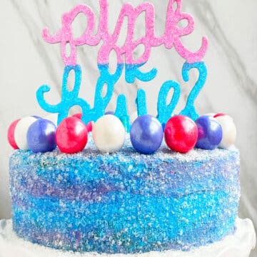 Easy Homemade Gender Reveal Cake With Pink and Blue Buttercream Icing on White Dish.