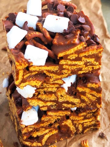 Stack of Easy No Bake Smores Bars on Brown Parchment Paper.