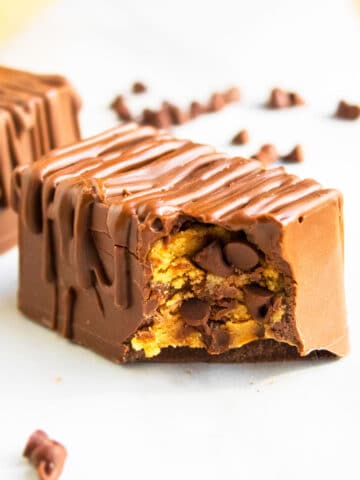 Easy Homemade Eggless Peanut Butter Cookie Dough Bars With Chocolate Chips on White Marble Background.