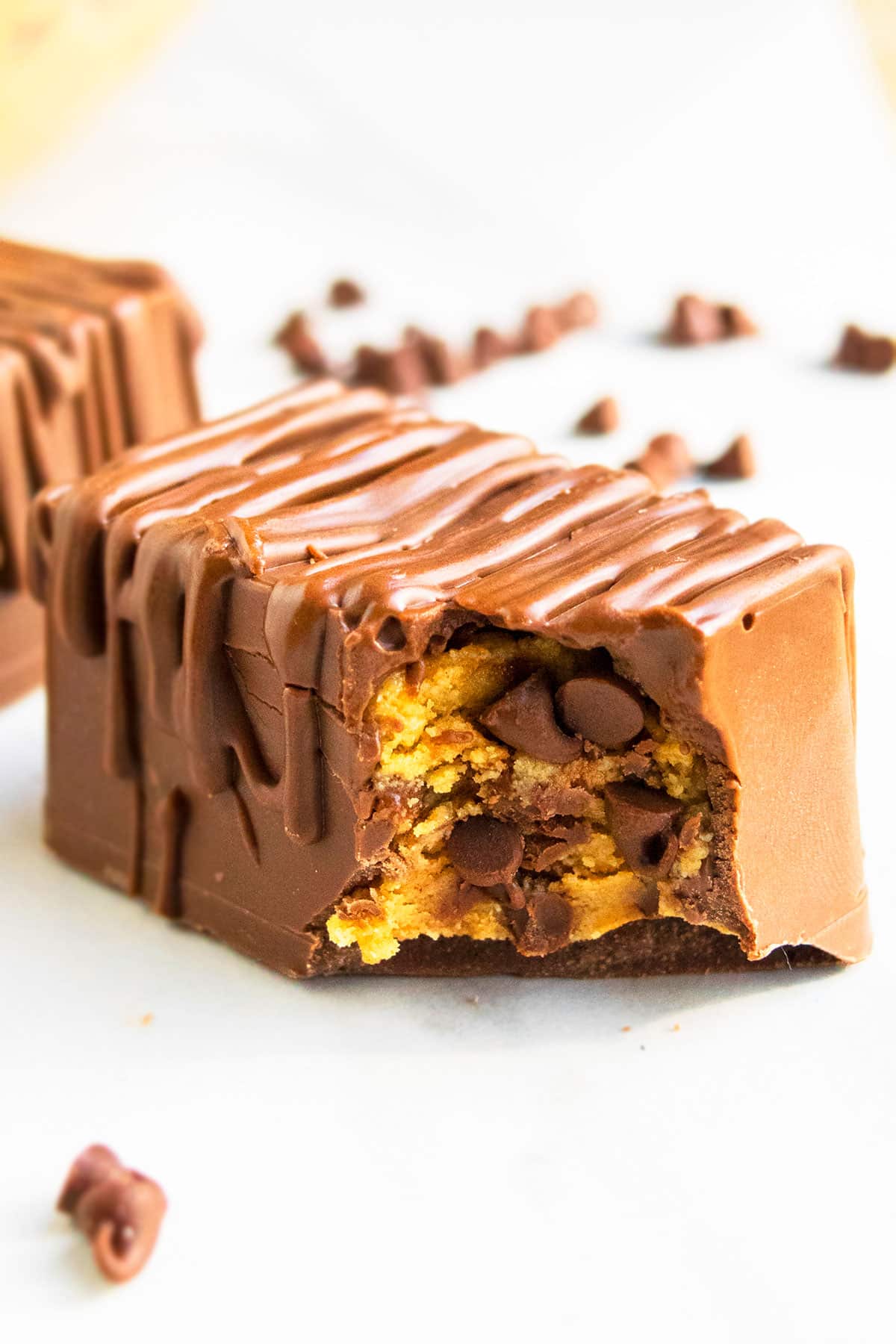 Easy Homemade Eggless Peanut Butter Cookie Dough Bars With Chocolate Chips on White Marble Background. 