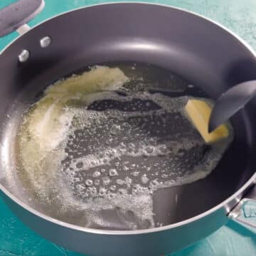 Butter  being heated in a large nonstick pot. 