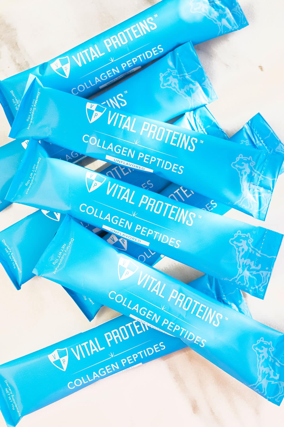 Packets of Protein Powder on White Marble Background. 