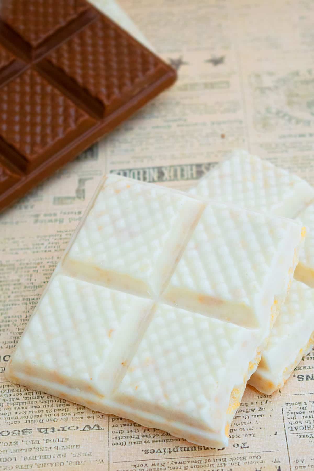 Homemade White Chocolate Crunch Bars on Sheet of Newspaper. 