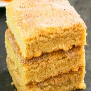 Easy Snickerdoodle Bars Stacked on a Rustic Gray Background.