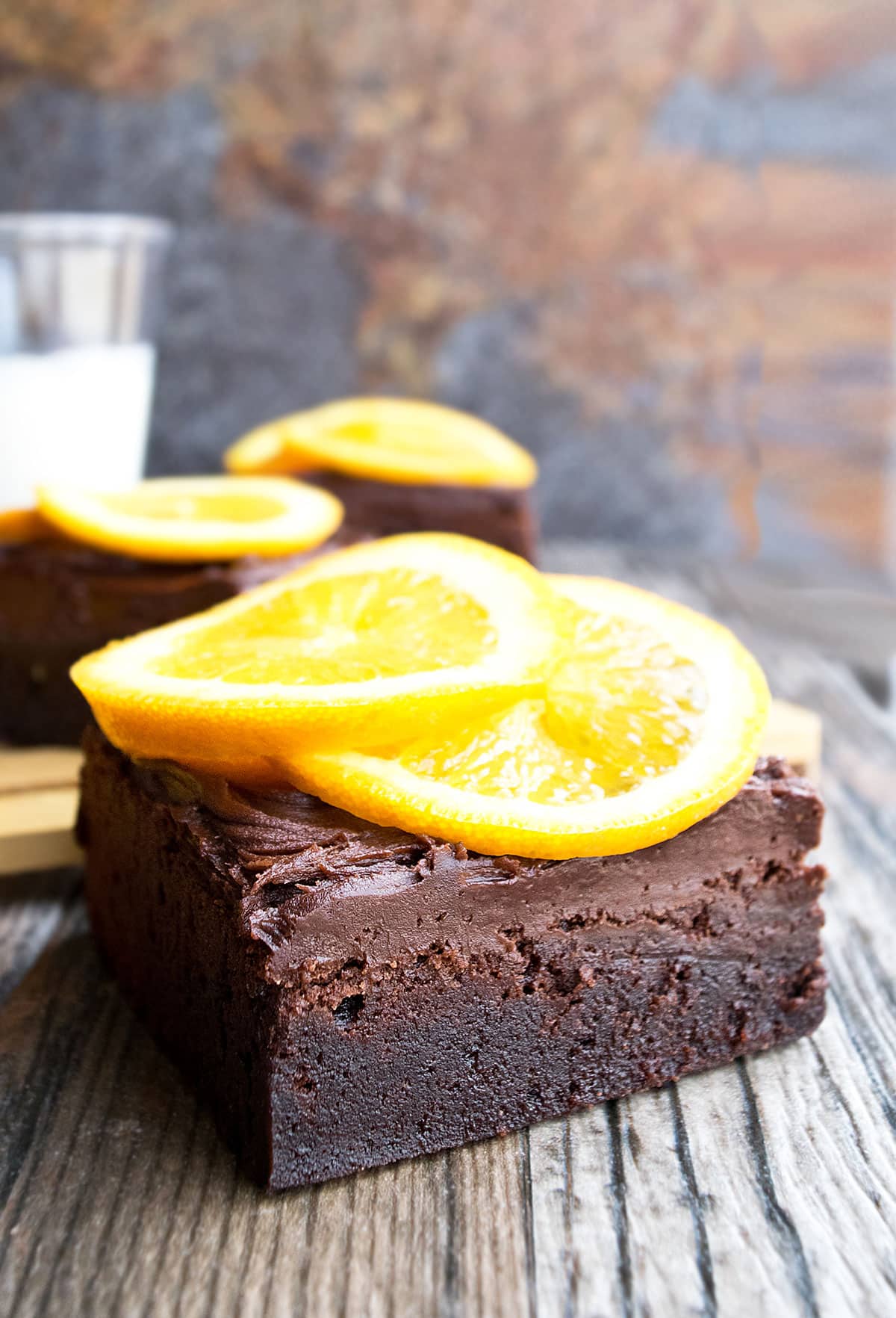 Slice of Chocolate Orange Brownies With Chocolate Buttercream Frosting and Fresh Orange Slices. 