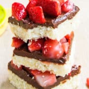 Stack of Easy Chocolate Coconut Bars on Wood Background.