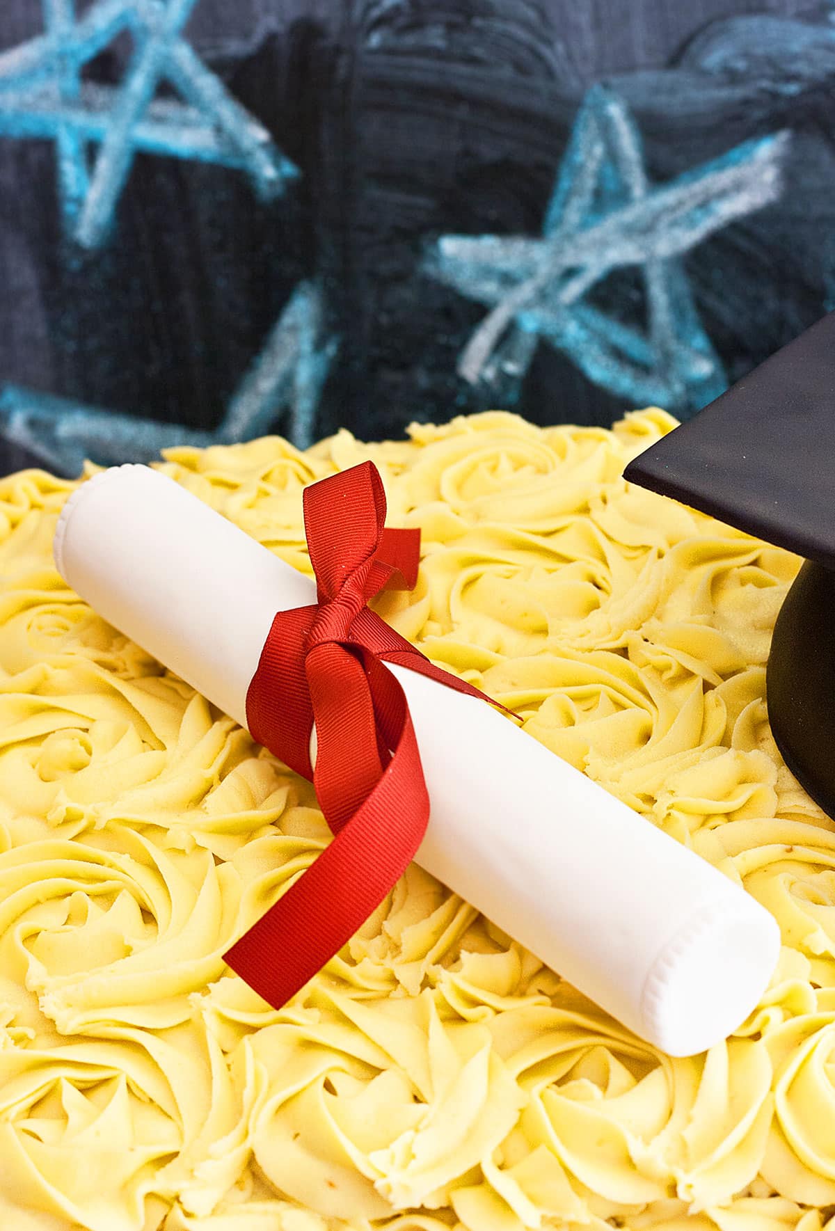 Closeup Shot of Edible Rice Krispie Treat Diploma With Red Bow on Top of Cake. 