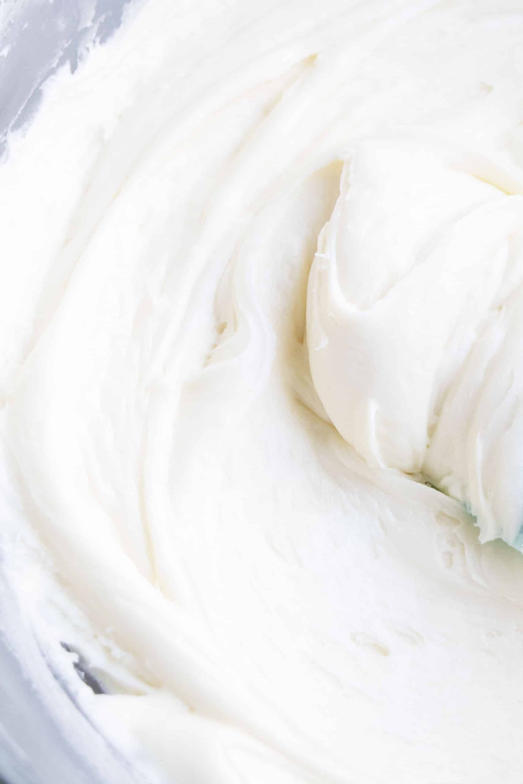 Closeup Shot of Sweet and Tangy White Icing in Glass Bowl. 