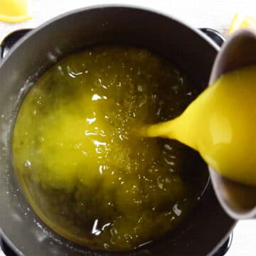 Orange juice being added to nonstick pot. 