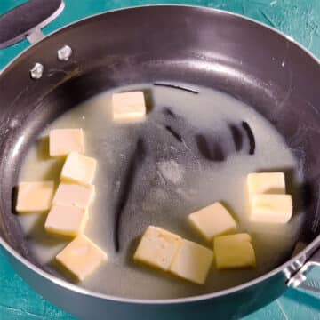Nonstick Pot With Cubes of Butter Melting. 