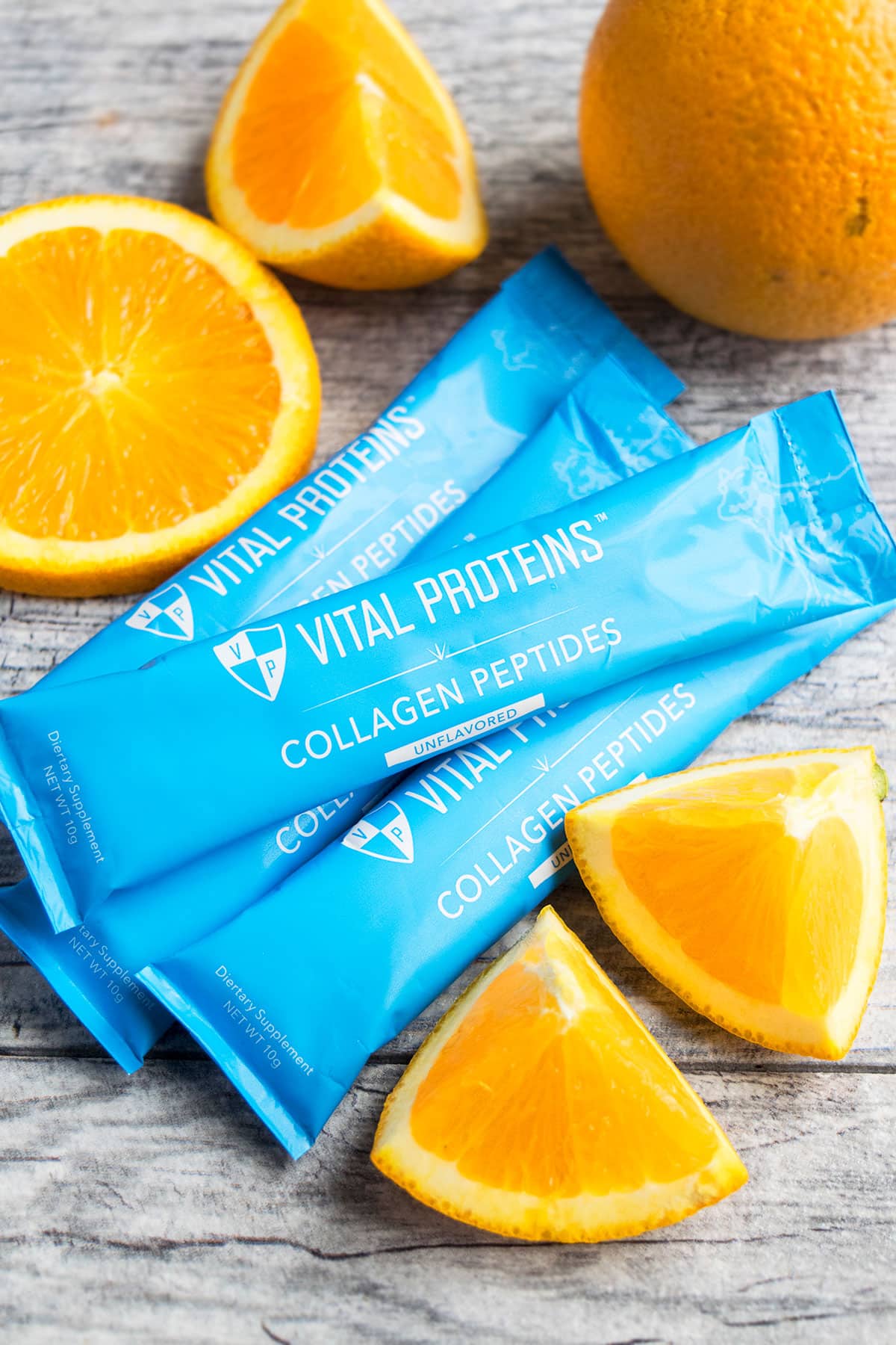 Blue Packets of Vital Proteins Collagen Peptides Packets on Rustic Gray Background. 