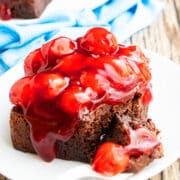 Slice of Gooey Brownies (Chocolate Cherry Brownies) on White Dish With Fork.