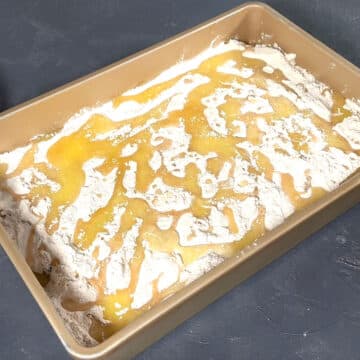 Melted butter poured on top of cake mix powder. 