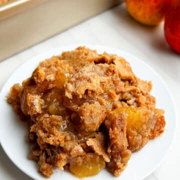 Easy Apple Dump Cake With Cake Mix on White Dish.