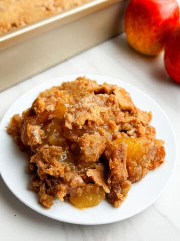 Easy Apple Dump Cake With Cake Mix on White Dish.