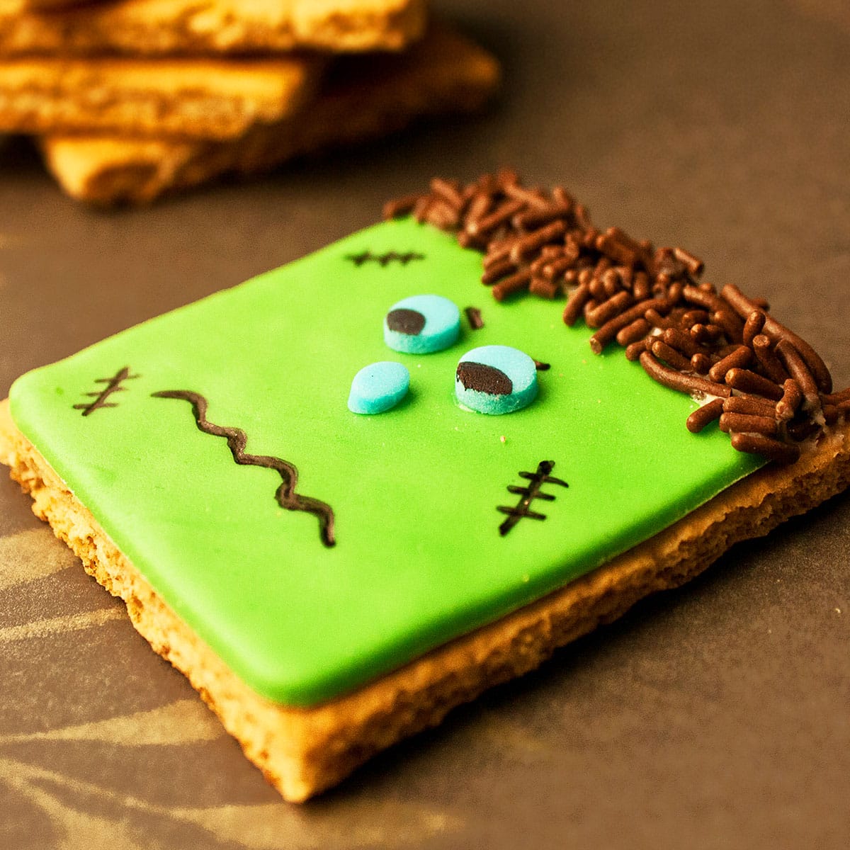 Closeup Shot of Decorated Halloween Biscuits on Brown Background. 