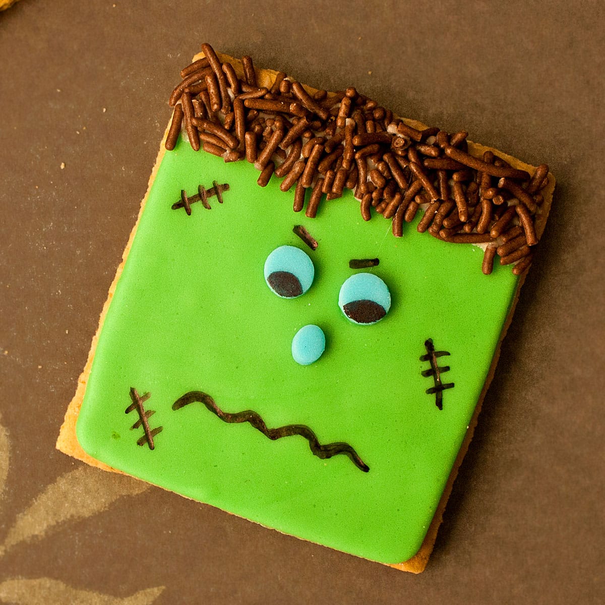 Easy Frankenstein Cookies For Halloween on Brown Background.