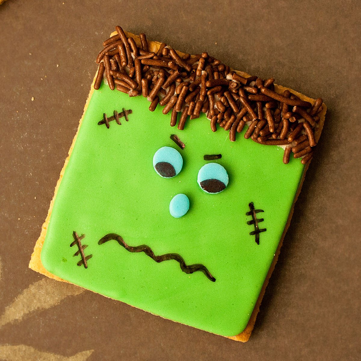 Easy Frankenstein Cookies For Halloween on Brown Background.