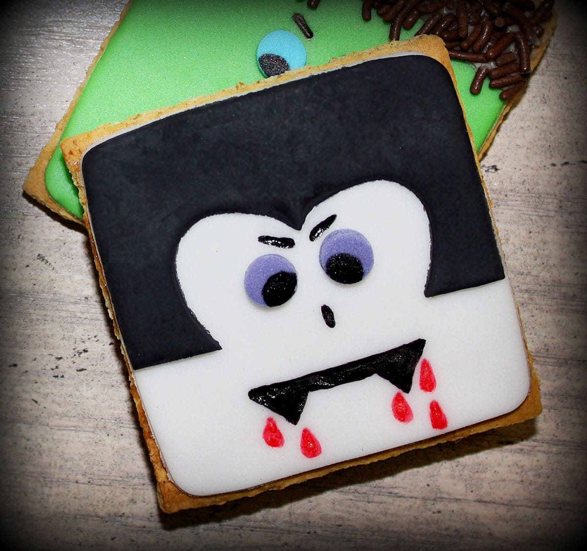 Easy Homemade Dracula or Vampire Cookies (Halloween Cookies) on Rustic Gray Background.