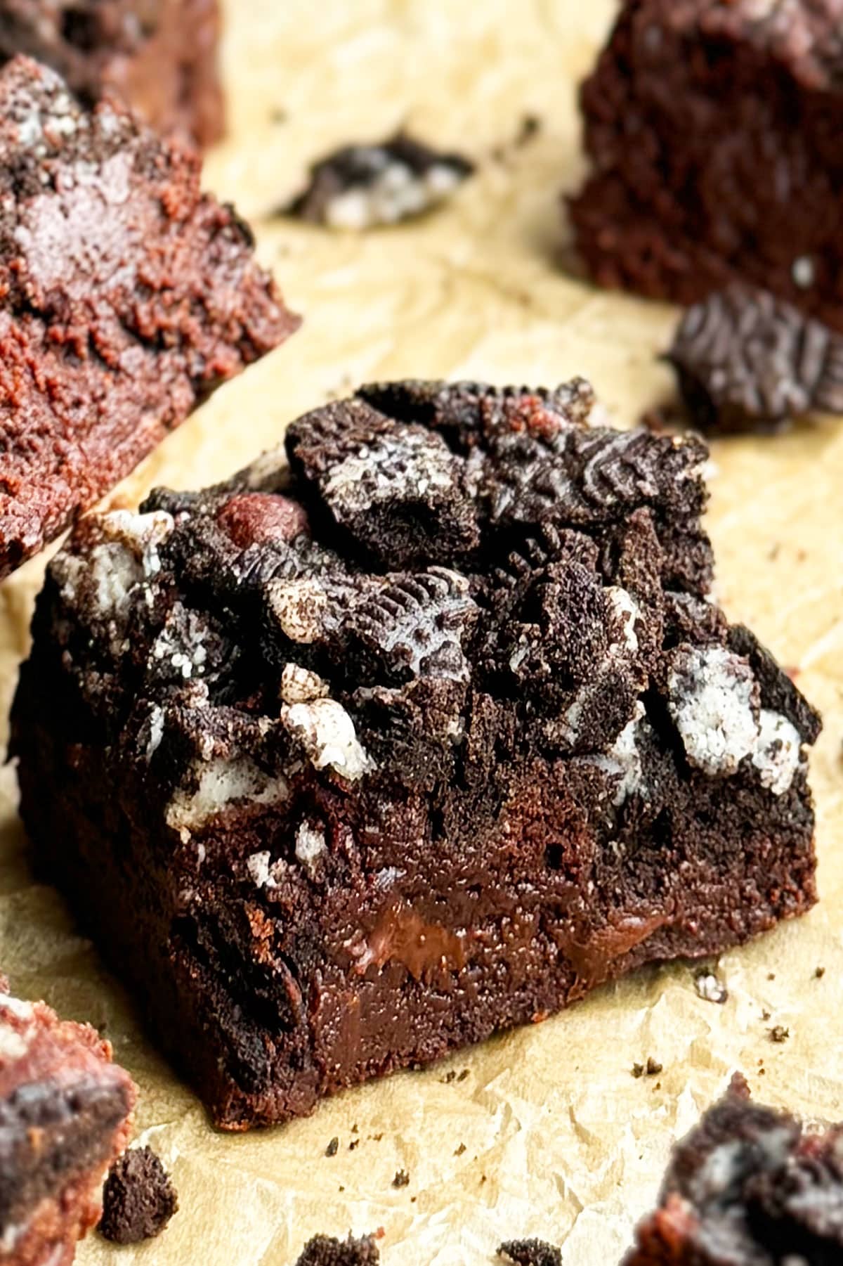 Slice of Fudgy Chocolate Brownie on Sheet of Brown Parchment Paper- Closeup Shot. 