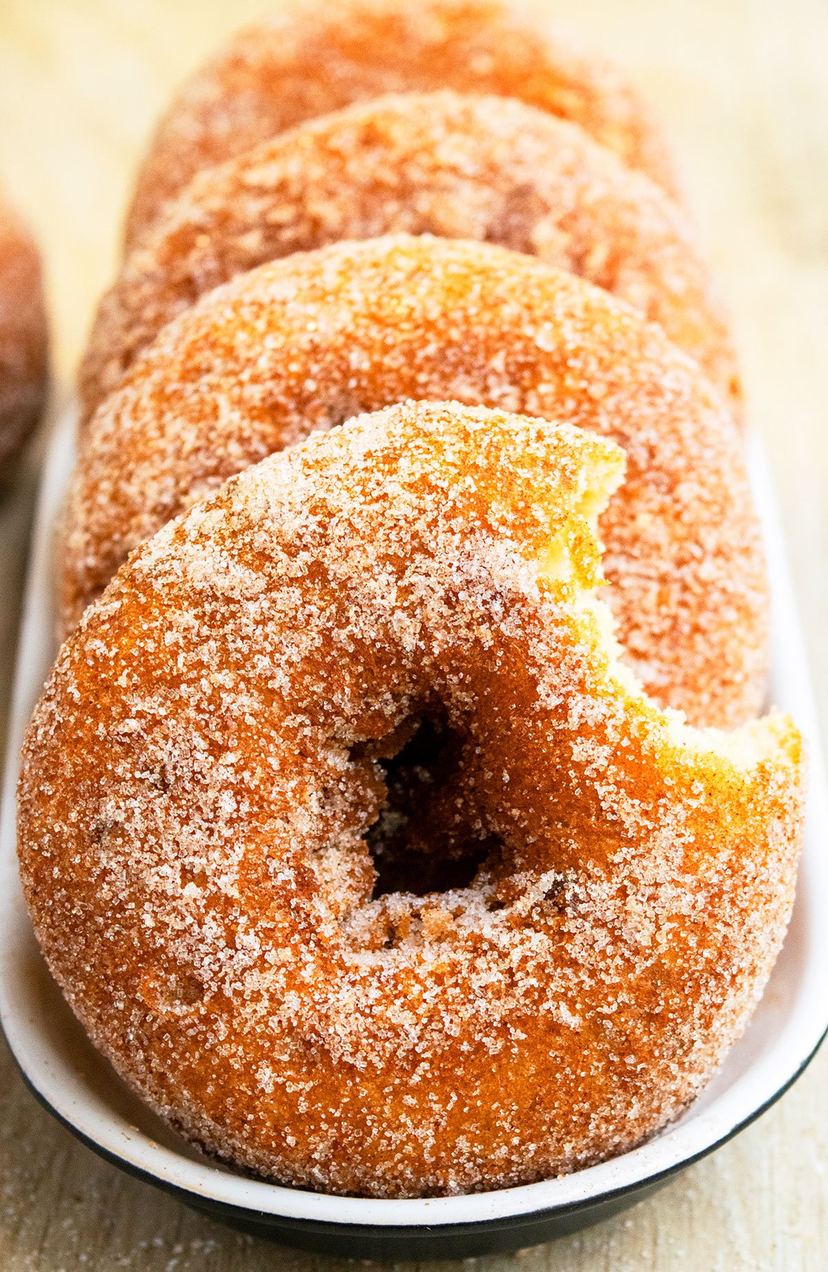 Partially Eaten Donut on Black and White Dish. 