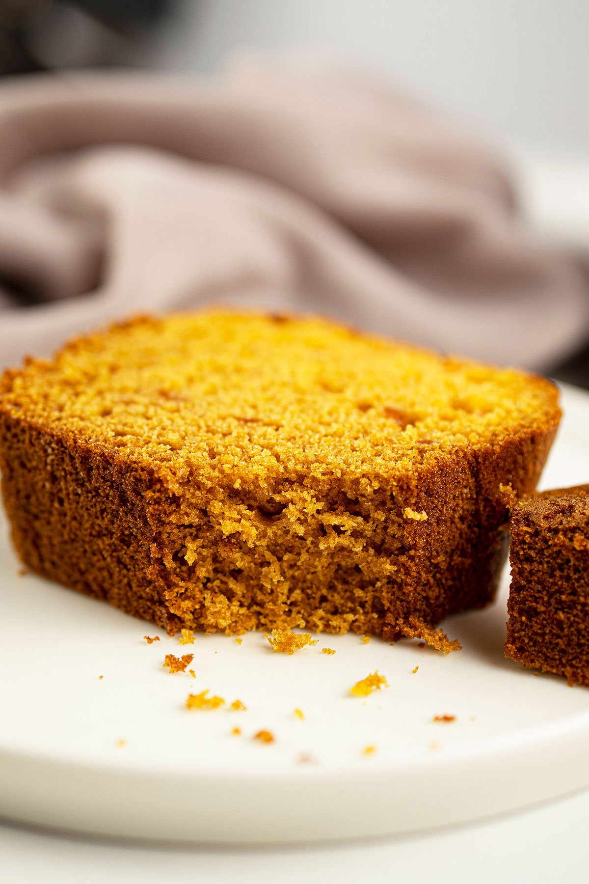 Slice of Sweet Bread That's Partially Eaten on White Dish. 