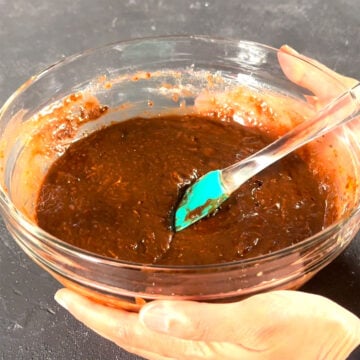 Glass bowl with chocolate brownie batter. 